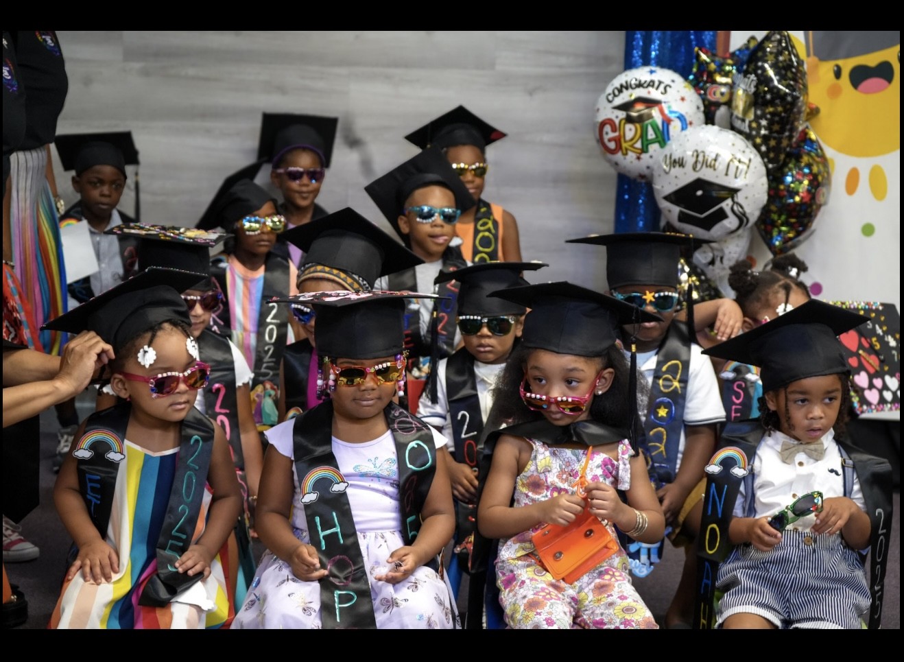 Academy graduates in caps and decorated stoles at the graduation ceremony